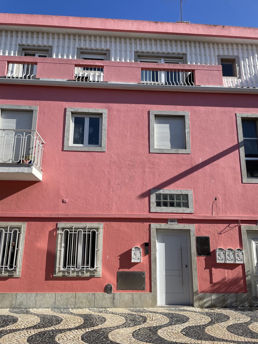 Pink house on a Portuguese cobblestone street